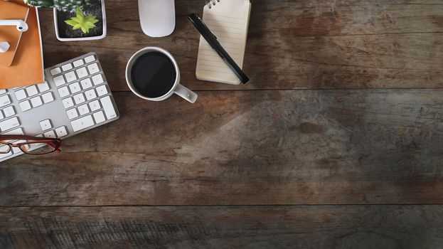 Copy space, Flat lay office desk with laptop, notebook, pencil, cactus and coffee cup on old rustic wood table.