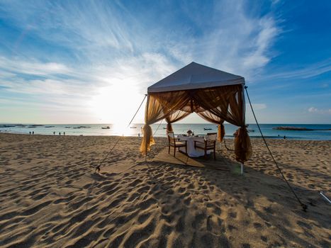 Dinner table at the beach at sunset in Bali