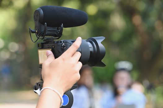 The photographer Video camera operator on stabilizers working with his equipment to pay close attention to take a photo. 