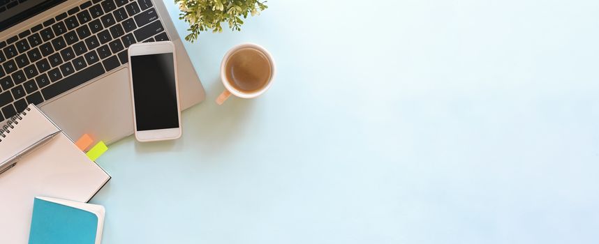 Simple Top view table - Creative flat lay office desk. Laptop, notebooks and coffee cup on white background. Panorama banner blue background with copy space.