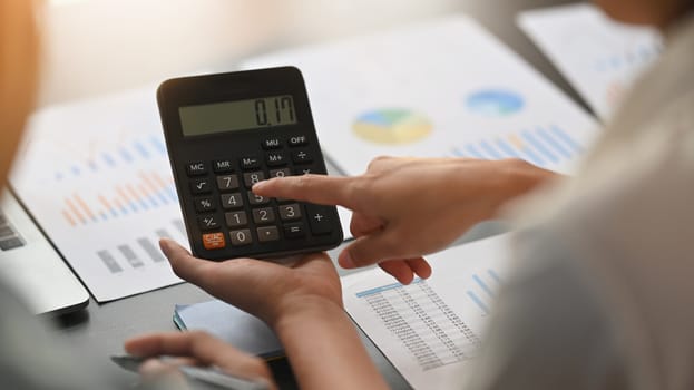 Close-up image of young business development team are calculating /discussing/brainstorming at the modern meeting table. Chart analysis concept.