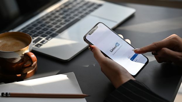 CHIANGMAI. Thailand. January 30, 2020. A women holds New iPhone 11 Pro Max with LinkedIn application on the screen.LinkedIn is a photo-sharing app for smartphones.