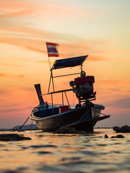 Traditionnal Long tail boat at sunset in Thailand