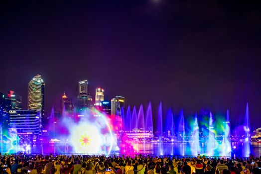 SINGAPORE CITY, SINGAPORE - MARCH 7, 2019: Front view of Spectra Light and Water Show Marina Bay Sand Casino Hotel Downtown Singapore