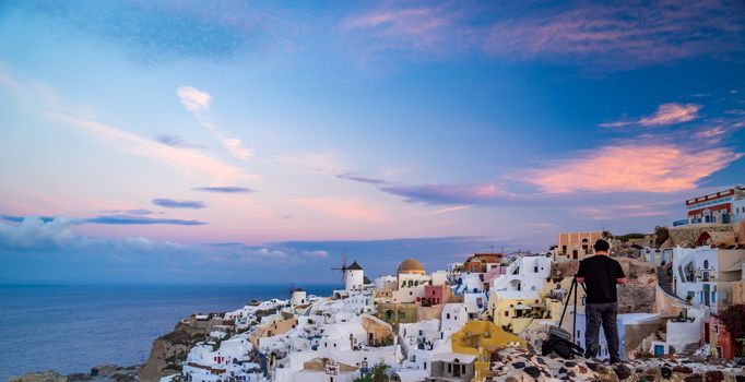 Taking photographs at Sunrise in Oia Santorini Greece