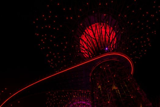 SINGAPORE - APRIL 21 2018 : Singapore Night Skyline at Gardens by the Bay. SuperTree Grove under Blue Night Sky in Singapore. Cityscape and city skyline in Singapore.