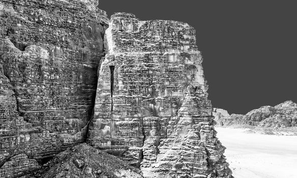 Black and white processed image of a large rock of the mountains in the desert of Wadi Rum, Jordan, middle east