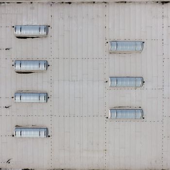 Aerial view of the flat roof of an industrial hall, as background, made with drone