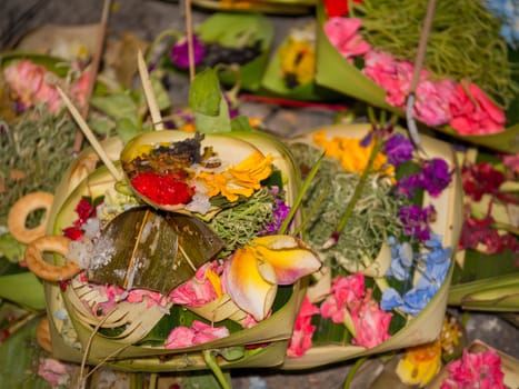 Offerings to gods in Bali with flowers, food and aroma sticks