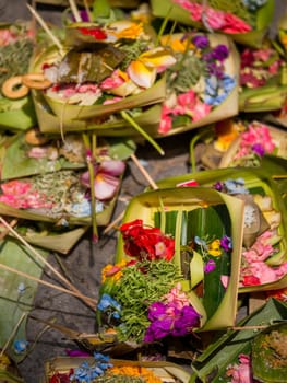 Offerings to gods in Bali with flowers, food and aroma sticks