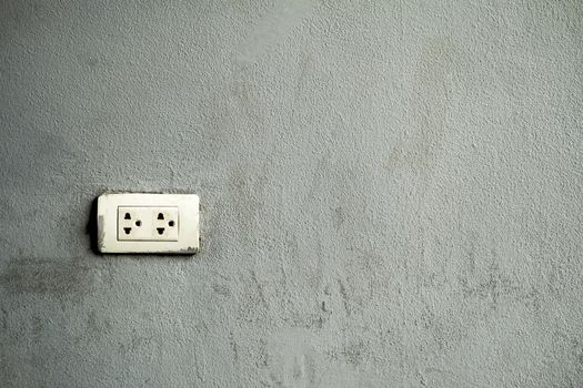 Electrical outlet Installed on a cemented background.