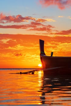 Rawai beach with andaman long tailed boat southern of thailand floating on clear sea water with sun shine in phuket