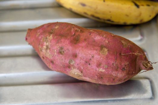 Sweet potato and plantain on a metallic background