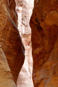 Narrow walls with colorful layered sandstone in the Siq in the rock city and necropolis Petra, Jordan, middle east