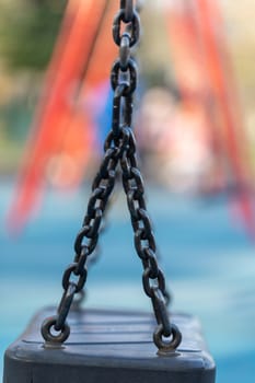 Blurred image of swings in a playground setting