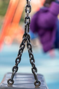 Blurred image of swings in a playground setting