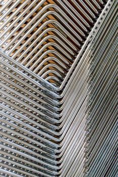 Abstract image of the metallic legs of stacked chairs