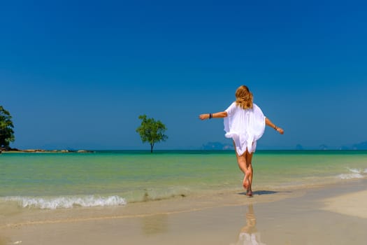 Woman walking on the beach in Krabi 
