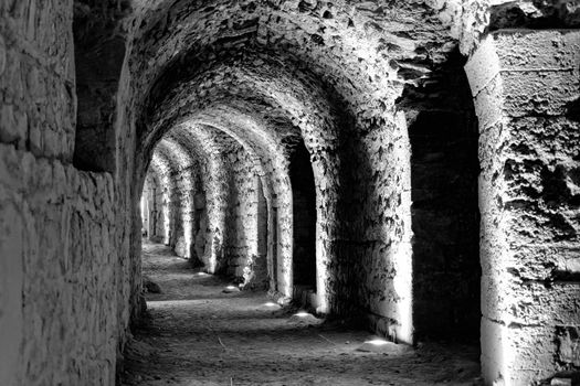 Black and white developed photo of the interior of the castle Karak with electric lights attached for the tourists and visitors, Jordan