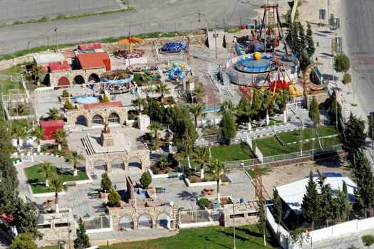 View from above of a small amusement park with play equipment for children on the edge of Karak, Jordan, middle east