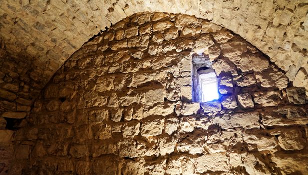 End of a passage through the fortress of Karak, Jordan, with a small window at the upper end of the wall, middle east