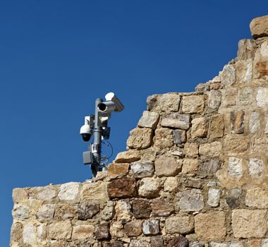 Modern video surveillance system on the old walls of the crusader fortress of Karak, Jordan, middle east