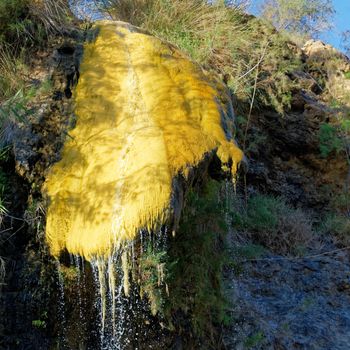 Yellow precipitation of sulphur at a secondary source of the hot springs of Main near Madaba just before the Dead Sea, jordan
