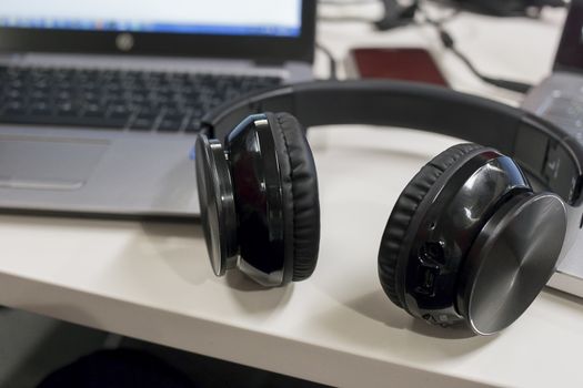 Laptops and bluetooth headphones in an office environment