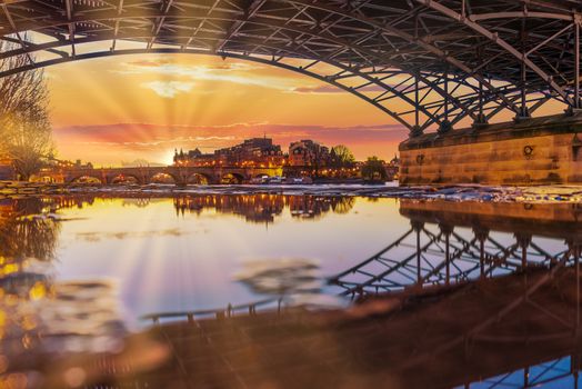 River Seine with Pont des Arts and Institut de France at sunrise in Paris, France