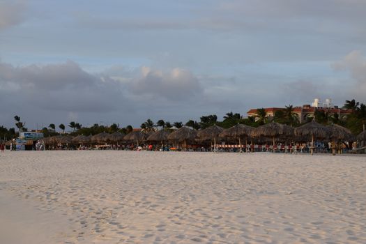 Beautiful golden sunset on the white beach of Aruba with turquoise water