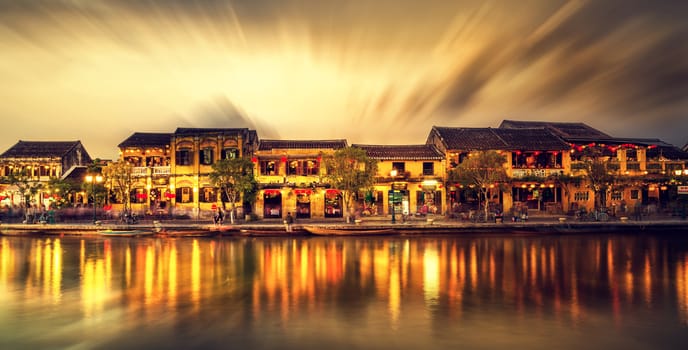 Hoi An Vietnam - February 2 2017: Street view with traditional boats on a background of ancient town in Hoi An Vietnam