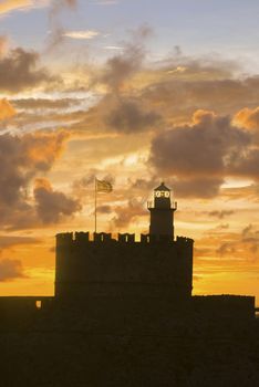 Agios Nikolaos fortress on the Mandraki harbour of Rhodes Greece at sunrise