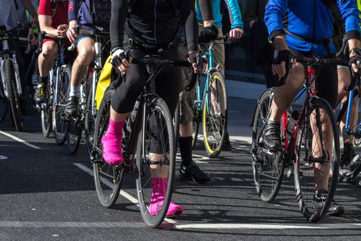 London cyclists commuting along a cycle lane during the morning rush hour