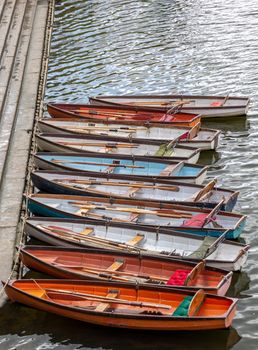 Wooden boats for hire moored on the River Thames, UK