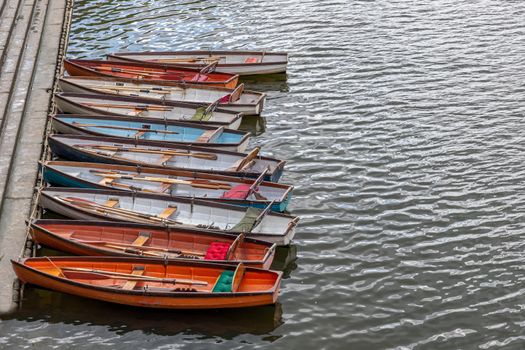 Wooden boats for hire moored on the River Thames, UK