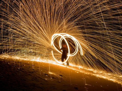 Amazing boy Fire Show at night on beach Thailand