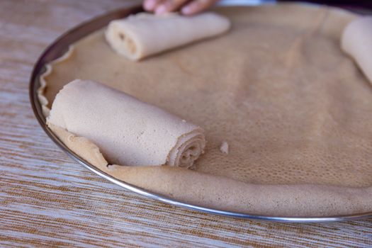 Injera is a sourdough flatbread made from teff flour.  It is the national dish of Ethiopia, Eritrea, Somalia and Djibouti