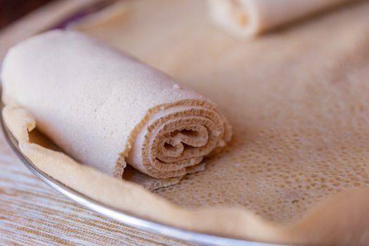 Injera is a sourdough flatbread made from teff flour.  It is the national dish of Ethiopia, Eritrea, Somalia and Djibouti