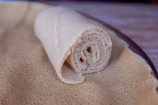 Injera is a sourdough flatbread made from teff flour.  It is the national dish of Ethiopia, Eritrea, Somalia and Djibouti