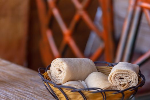 Rolls of Injera in a serving bowl.  Injera is a sourdough flatbread made from teff flour.  It is the national dish of Ethiopia, Eritrea, Somalia and Djibouti