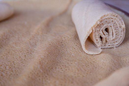 Injera is a sourdough flatbread made from teff flour.  It is the national dish of Ethiopia, Eritrea, Somalia and Djibouti