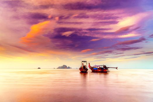 Traditional long-tail boat on the beach in Thailand at sunset