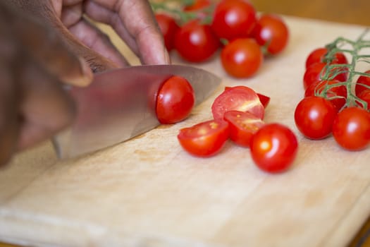 Black Man Slicing Tomatoes