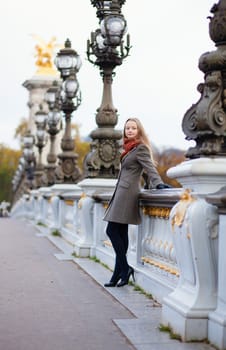 Beautiful girl with long blond hair on the Pont Alexandre III in Paris