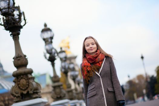 Beautiful girl walking on the Pont Alexandre III in Paris