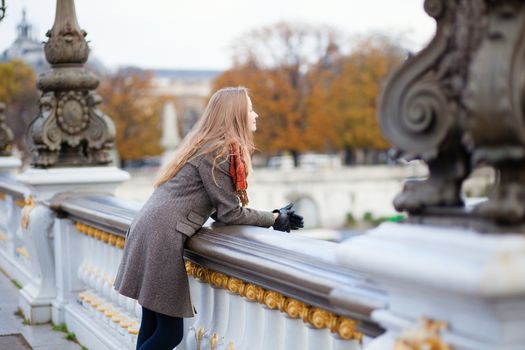 Beautiful young tourist in Paris on a fall or spring day