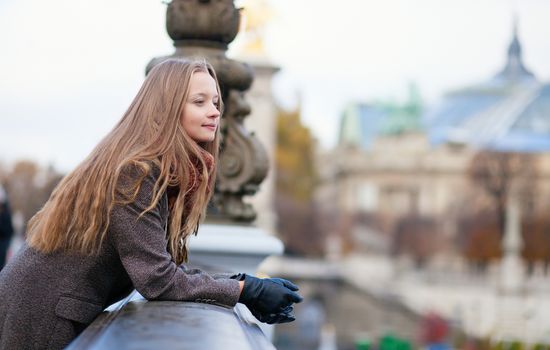 Young girl on a Parisian bridge, thinking