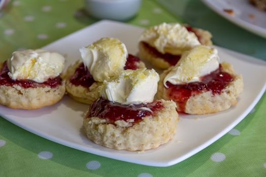 Cornish cream tea scones. Traditionally cream tea scones in Cornwall are served on a Cornish split, a sweet bread roll, with jam then cream on top.