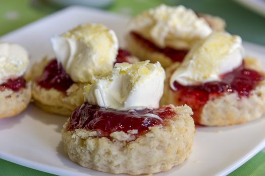 Cornish cream tea scones. Traditionally cream tea scones in Cornwall are served on a Cornish split, a sweet bread roll, with jam then cream on top.