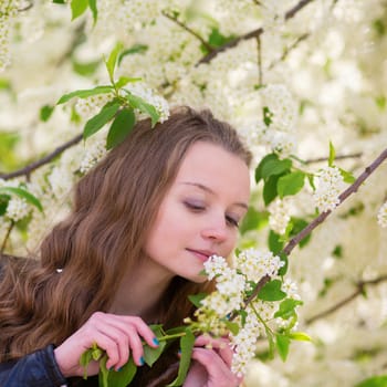 Beautiful young girl in a park on a spring day